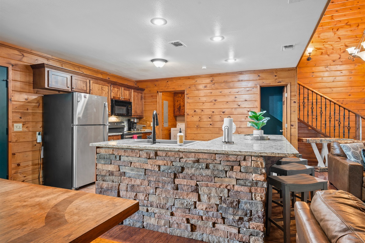 Stainless steel appliances and stonework touches make this kitchen both functional and beautiful.