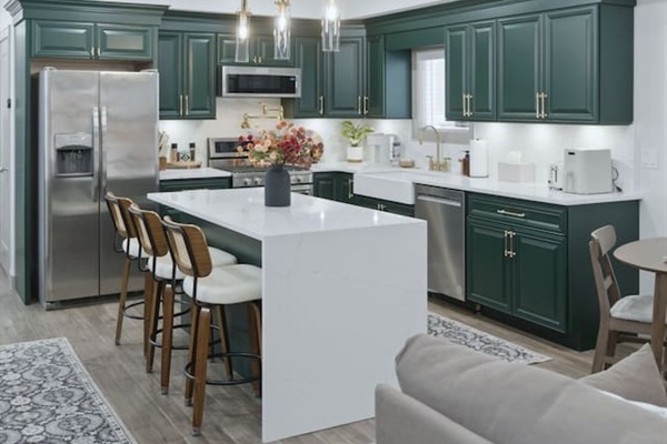 Elegant kitchen island with bar seating and stylish pendant lighting, creating a welcoming space to gather.