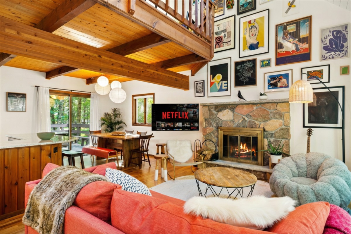 Living area with couch, comfy chairs, and gallery art wall