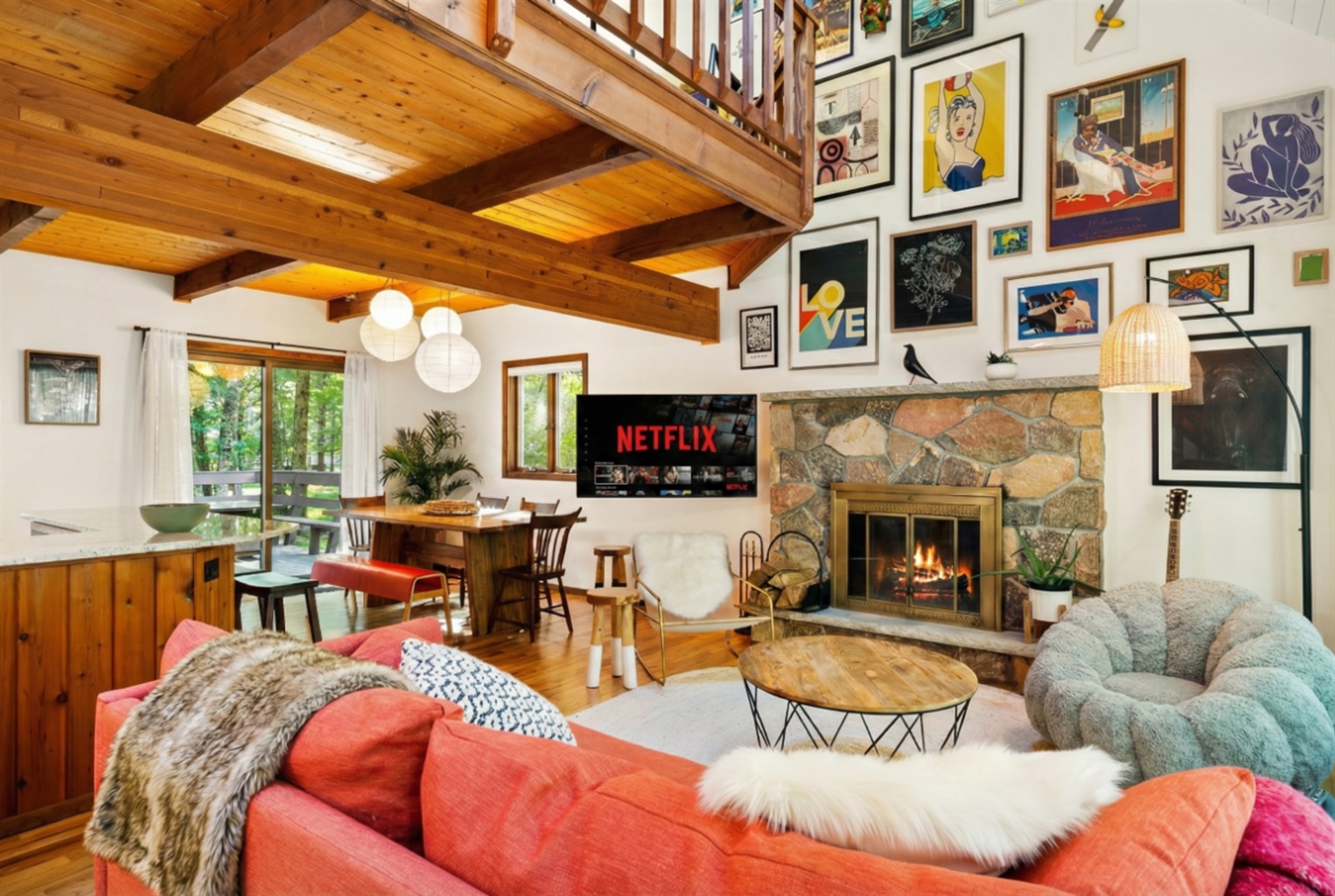 Living area with couch, comfy chairs, and gallery art wall