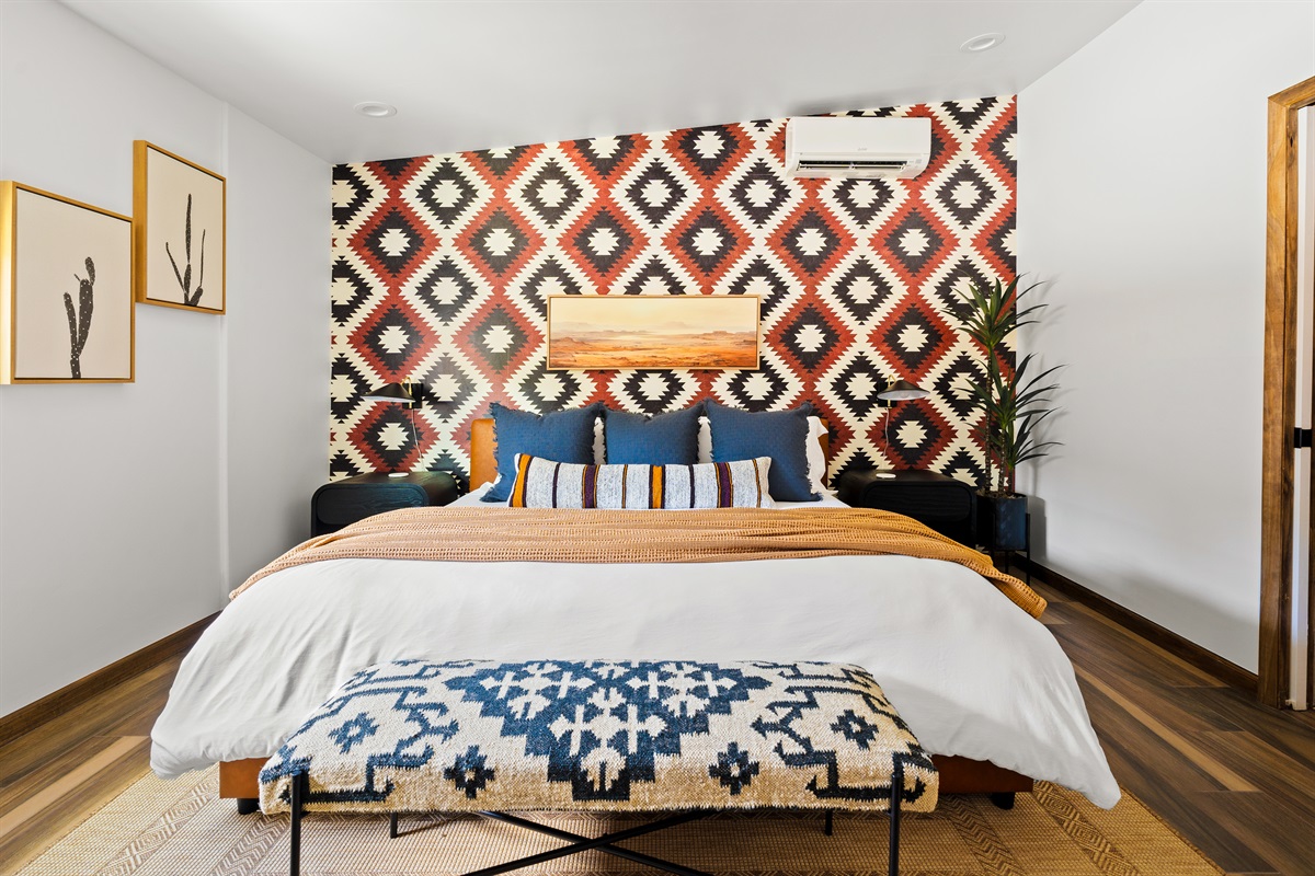 Stunning primary bedroom with a king bed, luxurious bedding, bold patterns, and a relaxing retreat vibe.