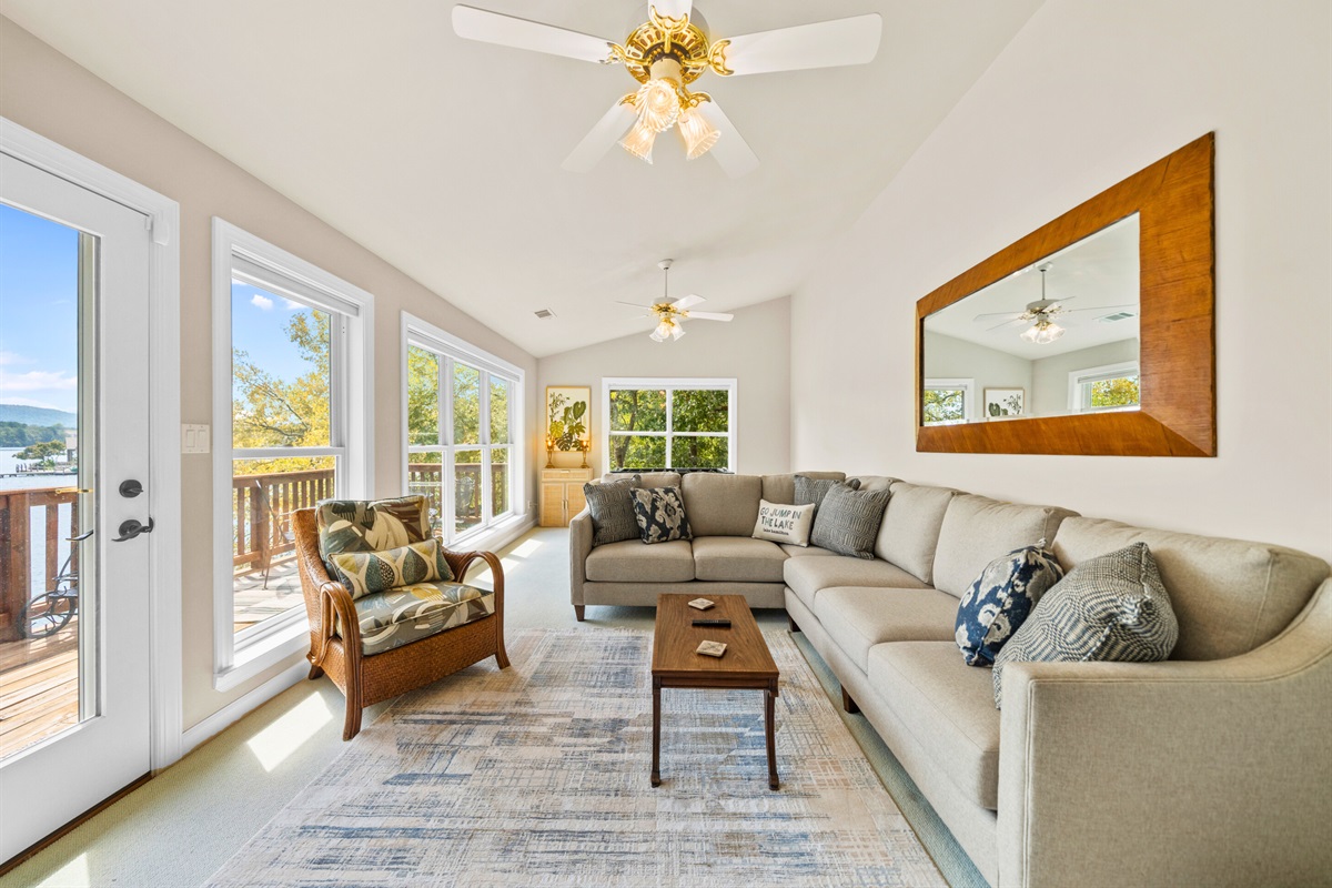 A sunroom with panoramic views and plush seating &mdash; your indoor retreat with an outdoor feel.