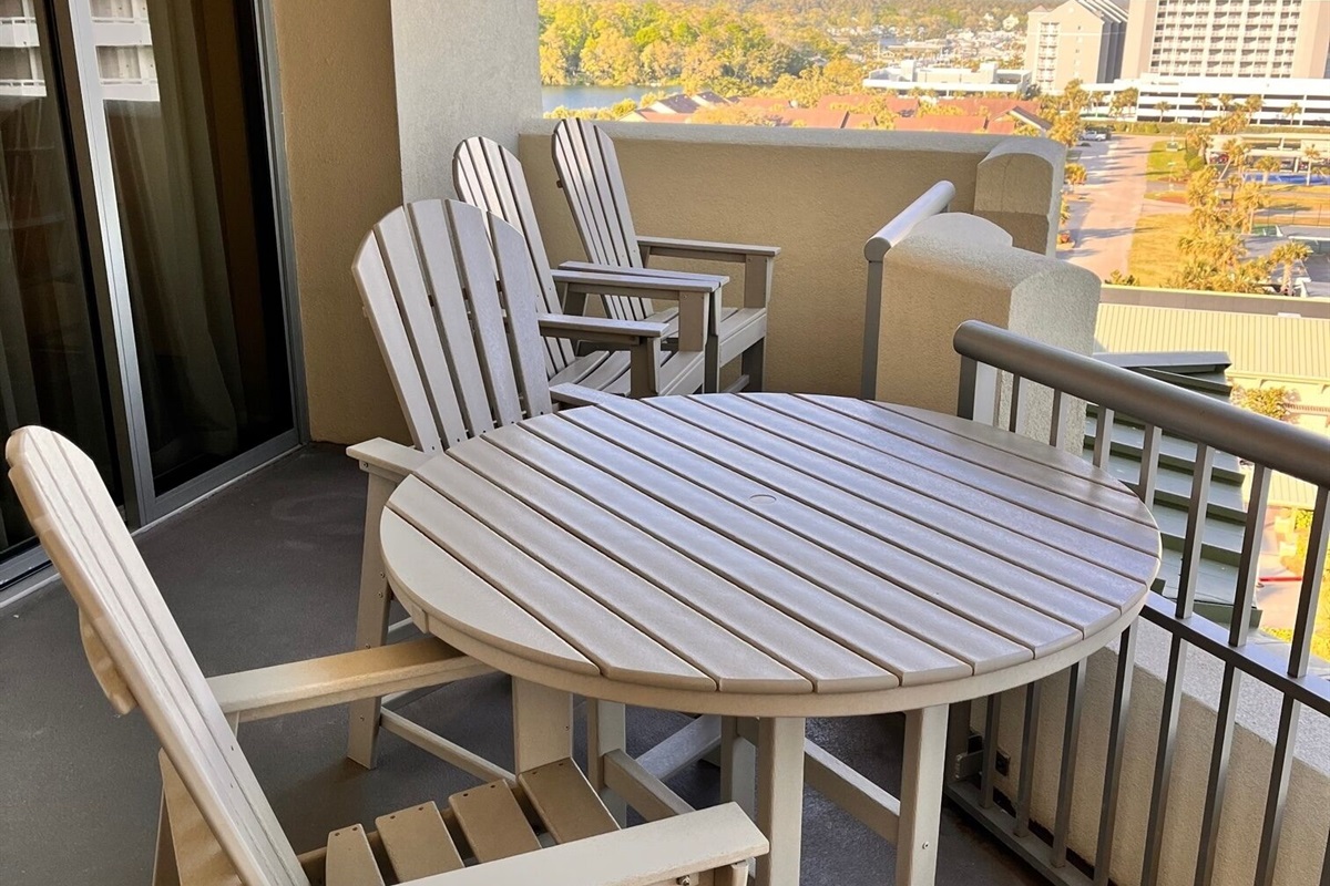 Four high top Adirondack chairs and 4 ft table for your meals with the view