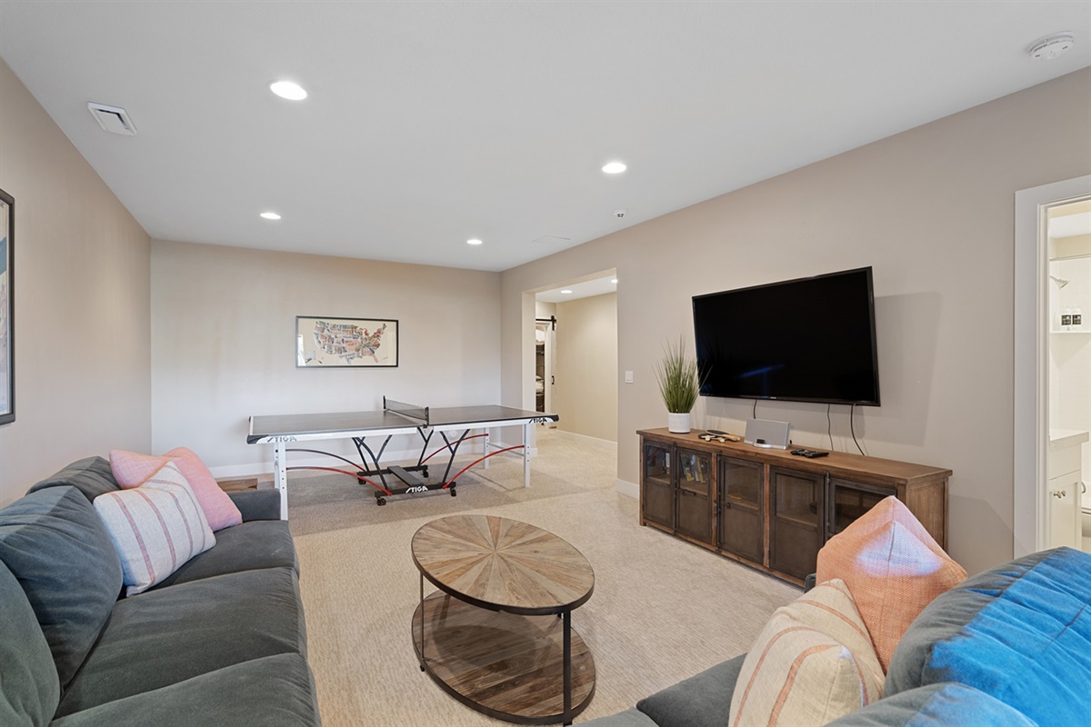 Large family room with a ping pong table and entertainment space.