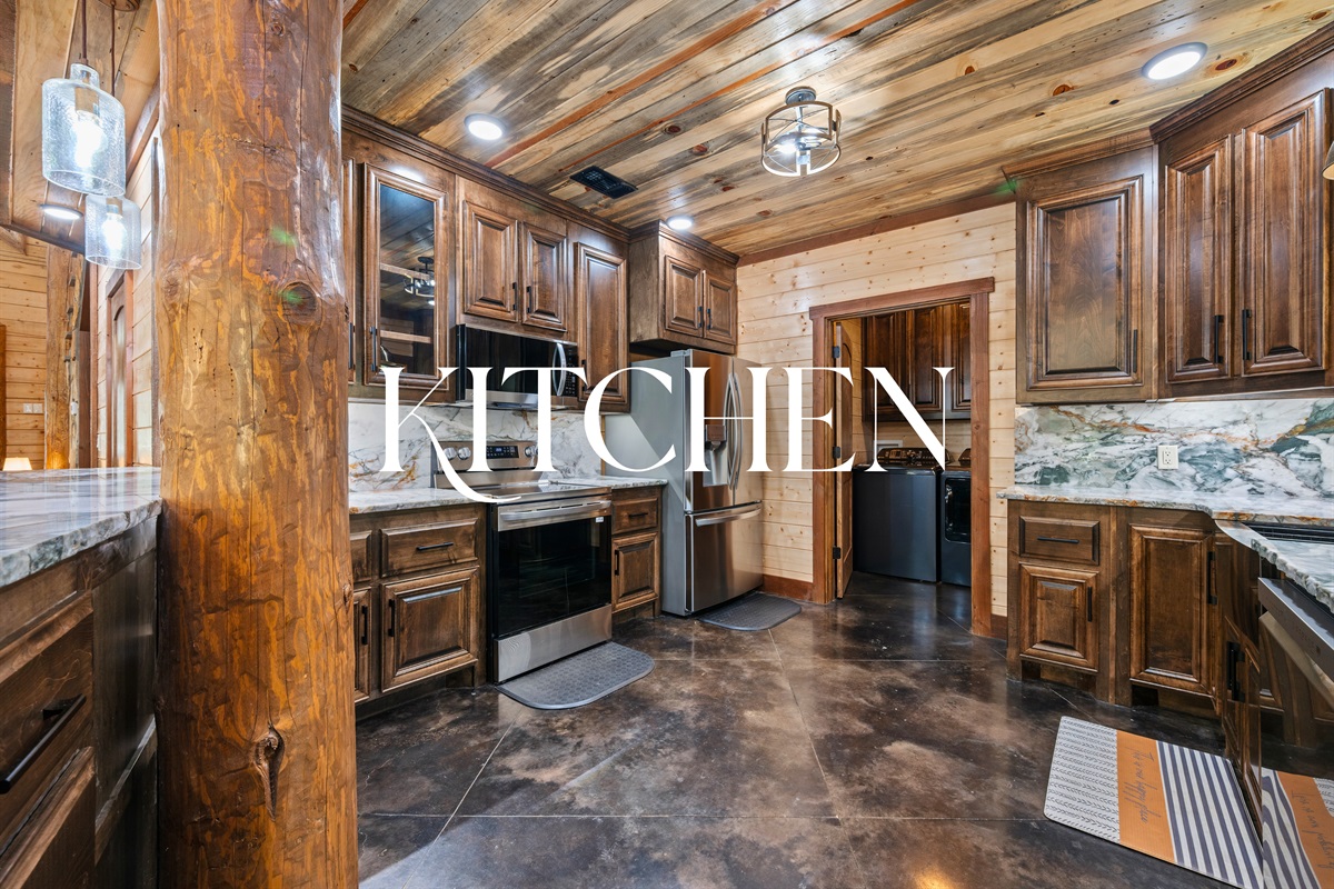 Fully equipped kitchen with stainless appliances and wood cabinetry.