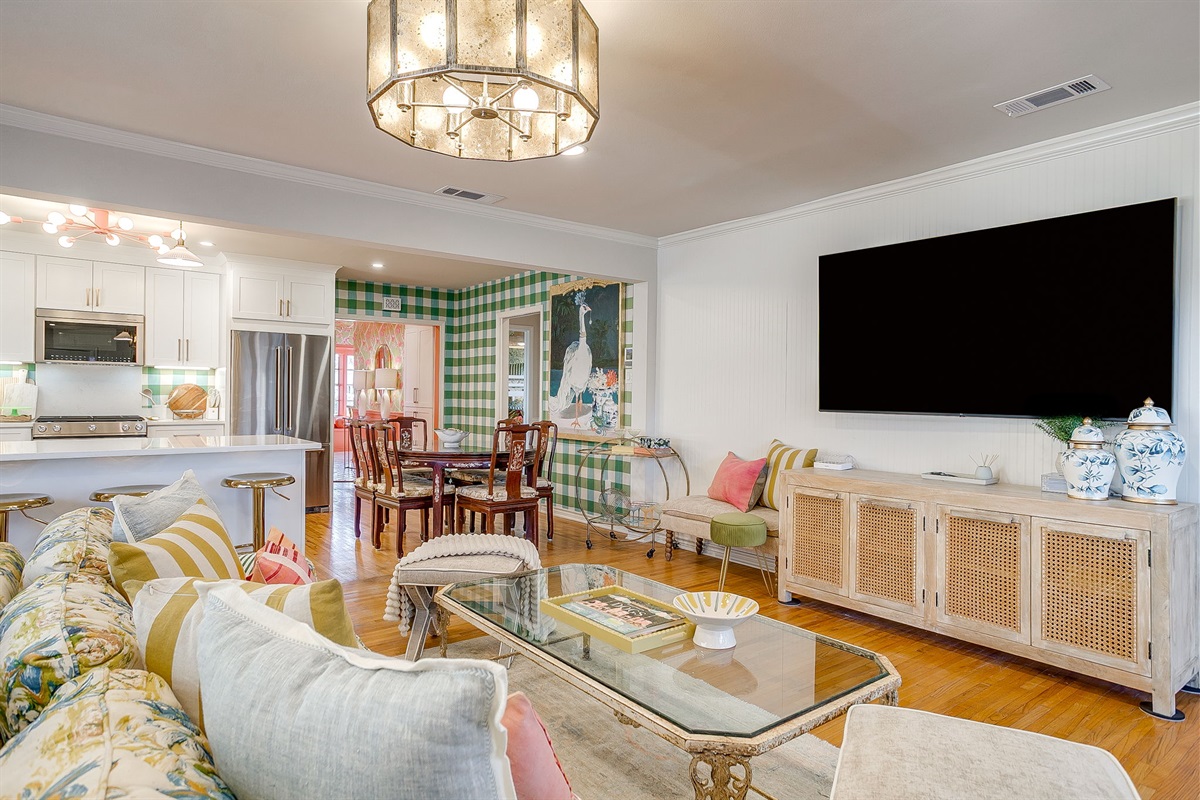 Bright open living area with 70" TV & dining flow.