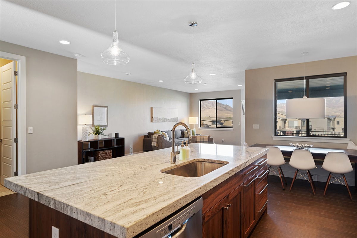 Modern kitchen with quartz countertops and open layout.