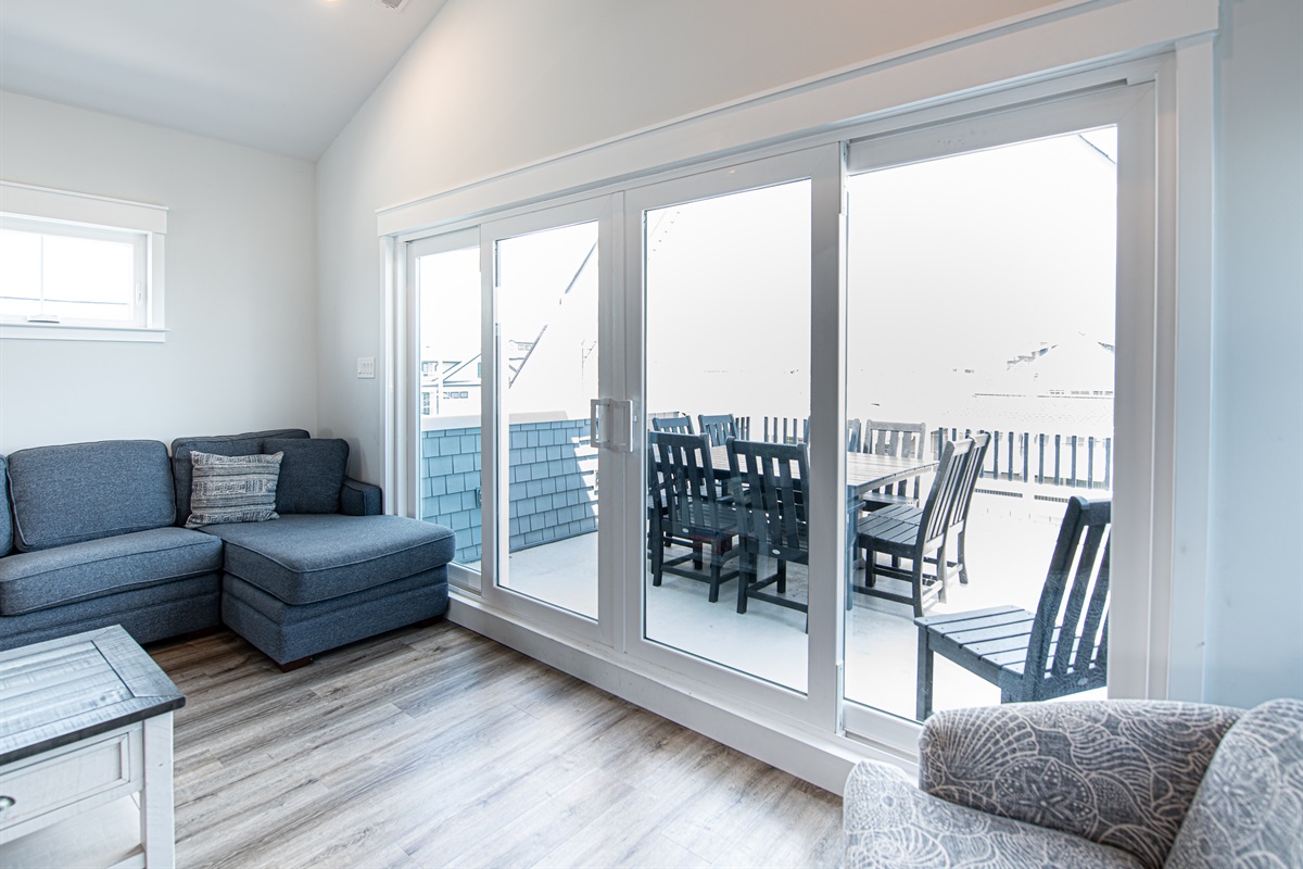 Living area looking out to balcony w/ ocean views