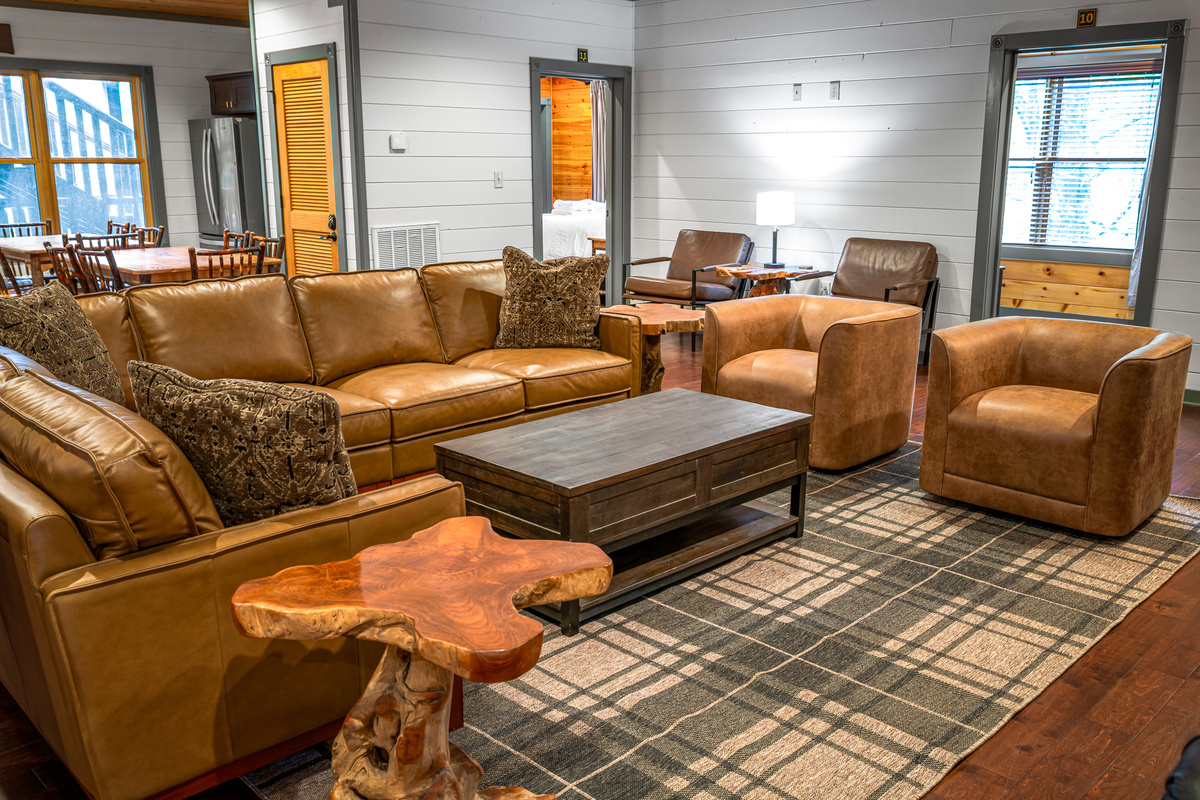 A 75" TV, roaring fireplace, and oversized Italian leather sectional anchor the main living room — with multiple separate hangout zones so the full group never feels crowded into one corner. Two pull-out beds.