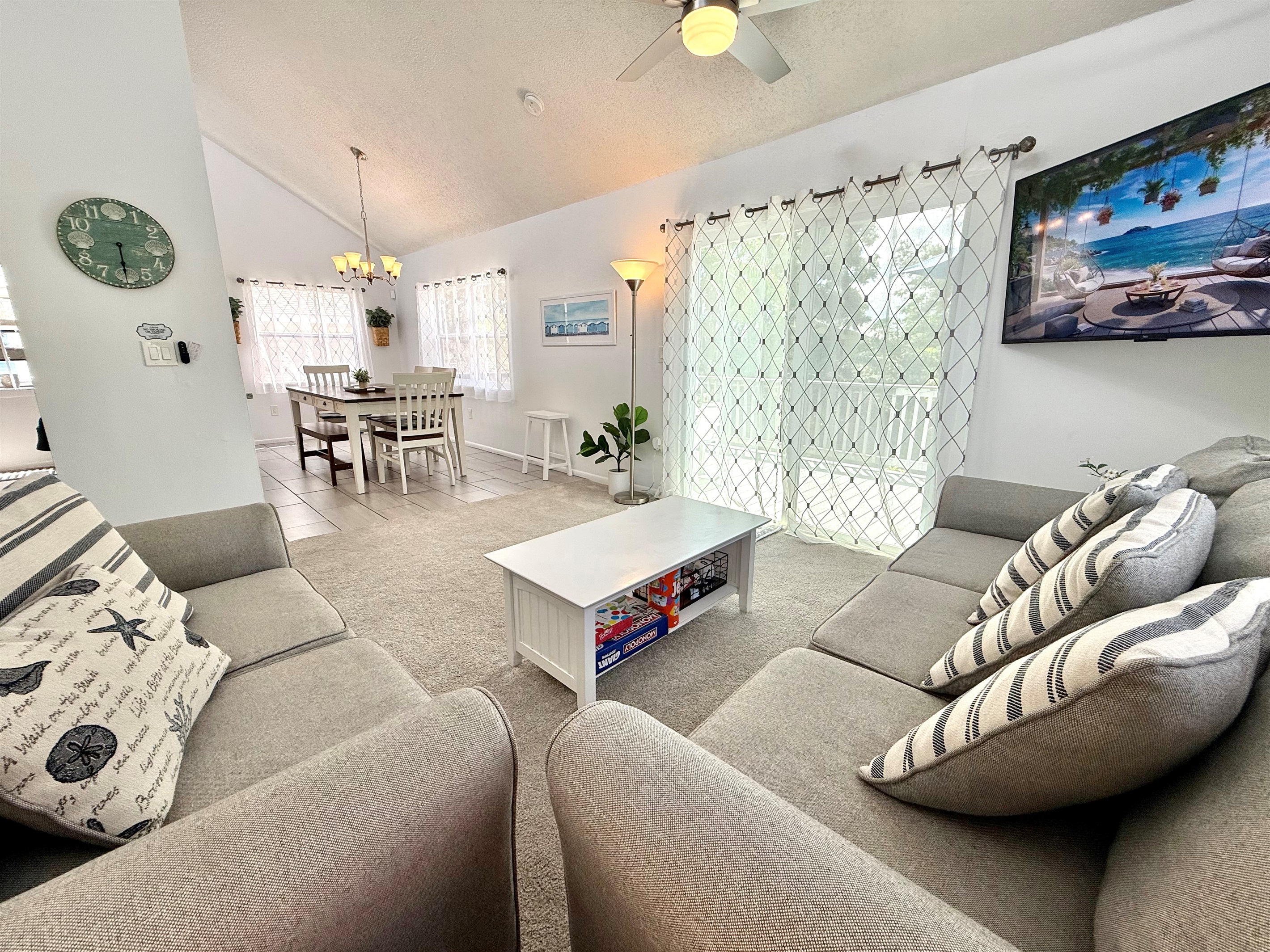 With its contemporary furniture, soft carpeting, and airy design, this living room offers both style and comfort for every guest.