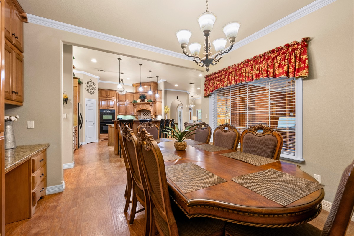 Dining area with seating for eight, connected to living room.
