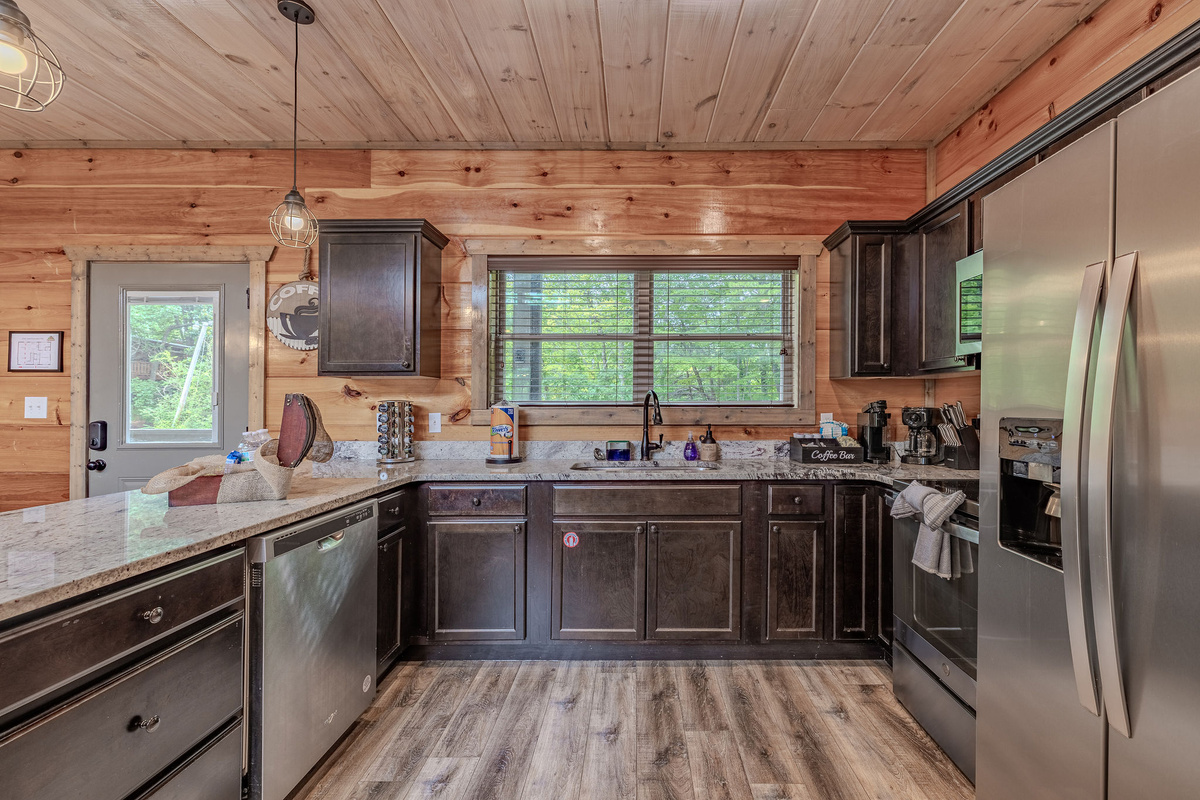 The kitchen includes full-size appliances, generous counter space, and the essentials for cooking at the cabin.