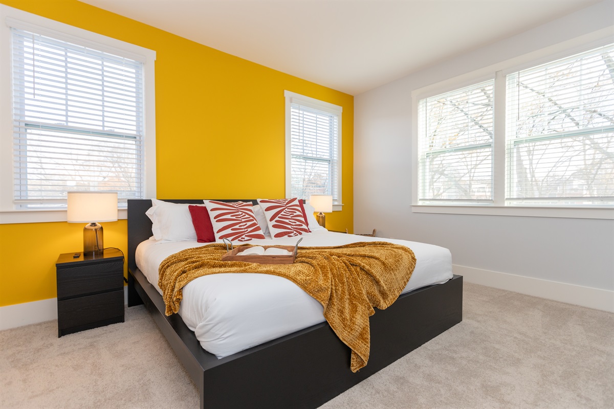 The luxurious king bedroom overlooks the spacious wooded backyard. No highway noise here. 
