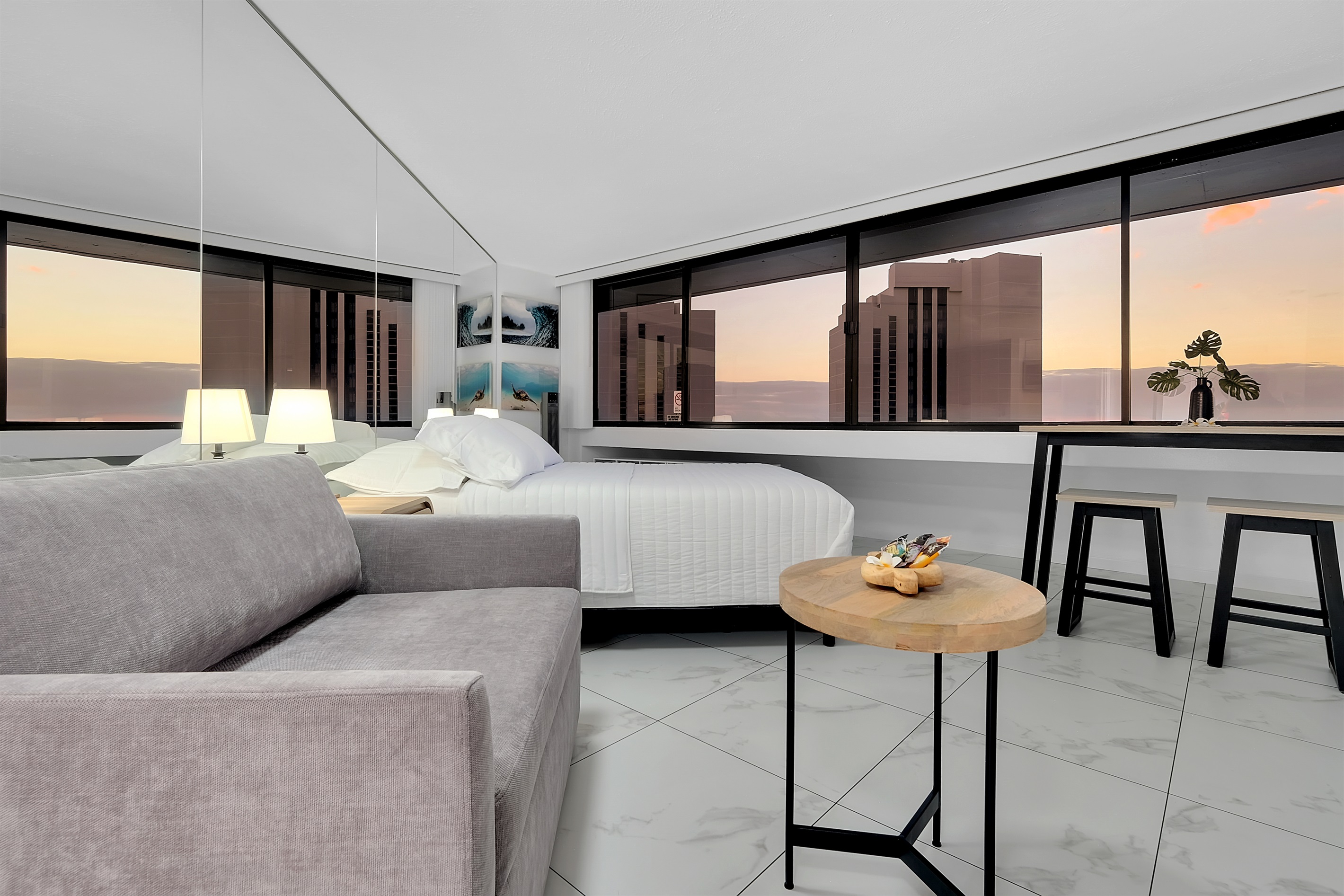 Unwind in this elegant Waikīkī suite featuring floor-to-ceiling windows, a cozy lounge area, and a panoramic view of the ocean and city skyline. Perfectly designed for relaxation, every sunset paints a picture of island tranquility.