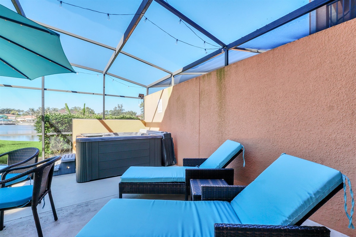 Private covered lanai with lounge area, dining area and hot tub