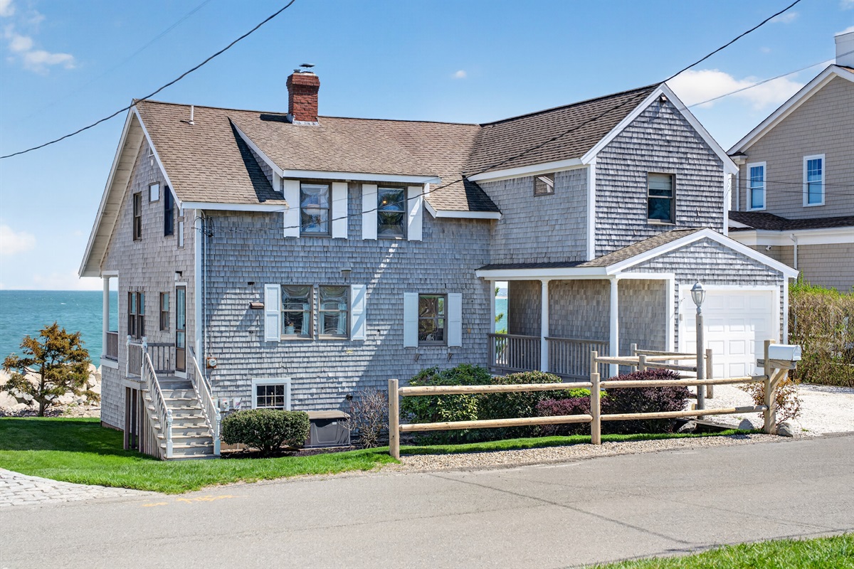 Charming seaside home featuring classic coastal architecture, a spacious lawn, and direct proximity to the shoreline—perfect for enjoying peaceful oceanfront living. 🌊🏡