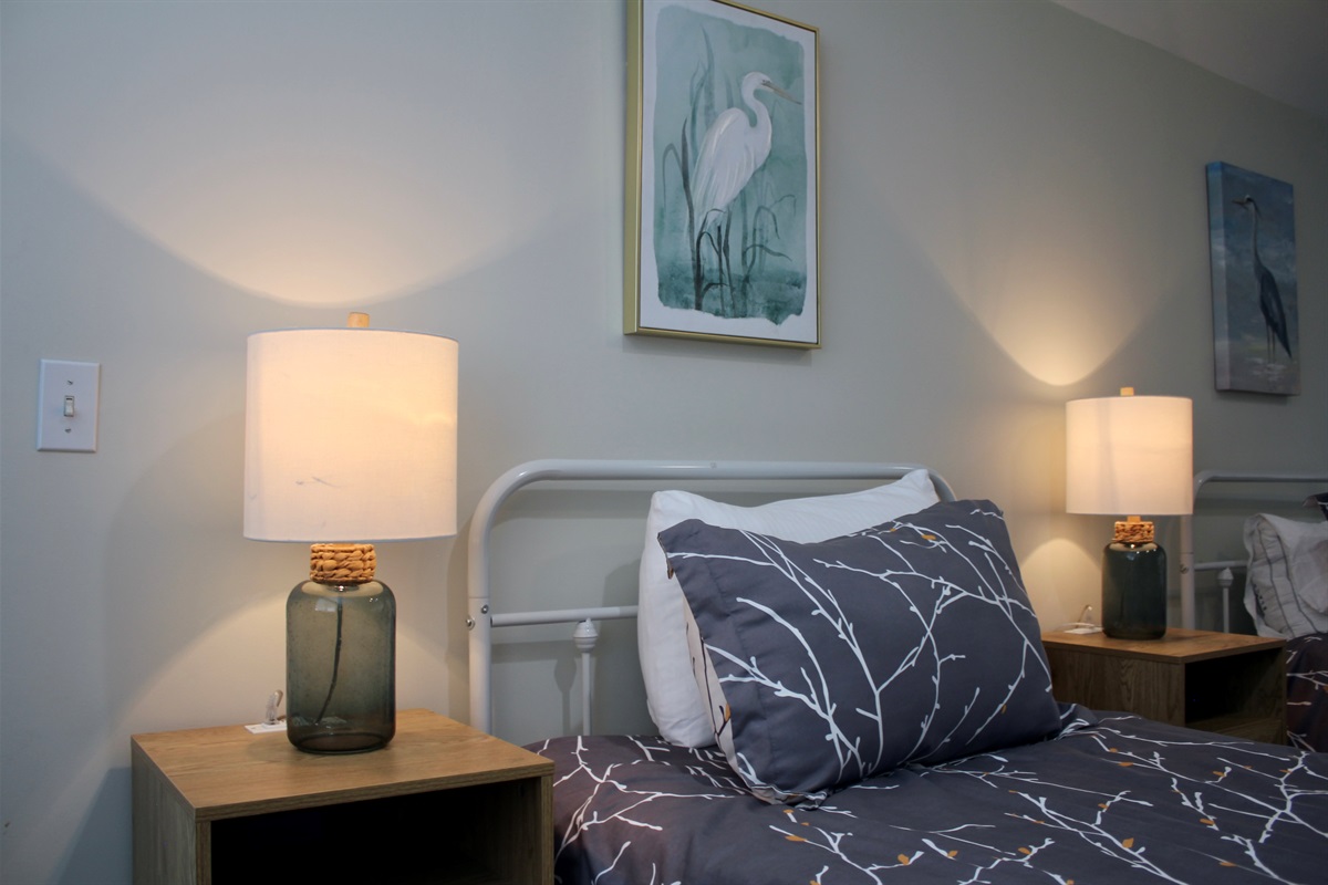 Sleep soundly beneath warm light and calming coastal décor.