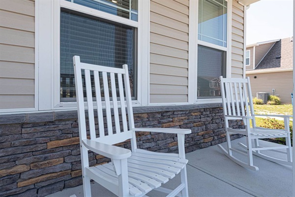Welcoming you to our abode, a covered front porch with two inviting rocking chairs invites relaxation. Here, stories unfold and memories are made, as gentle breezes and good company create the perfect sanctuary for moments of tranquility. 