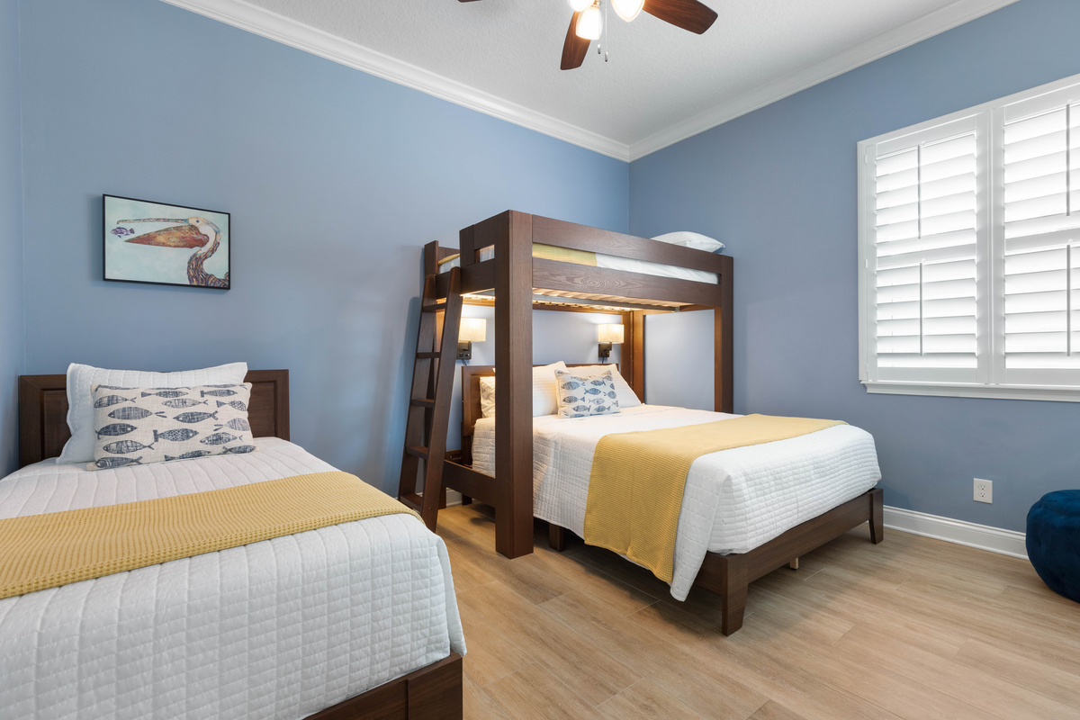 Periwinkle room with a queen under a twin loft plus a separate twin, a fun shared space for kids or cousins.