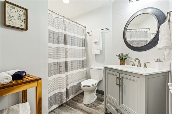The upper-level master bathroom offers a new shower-over-tub combo and complimentary toiletries.