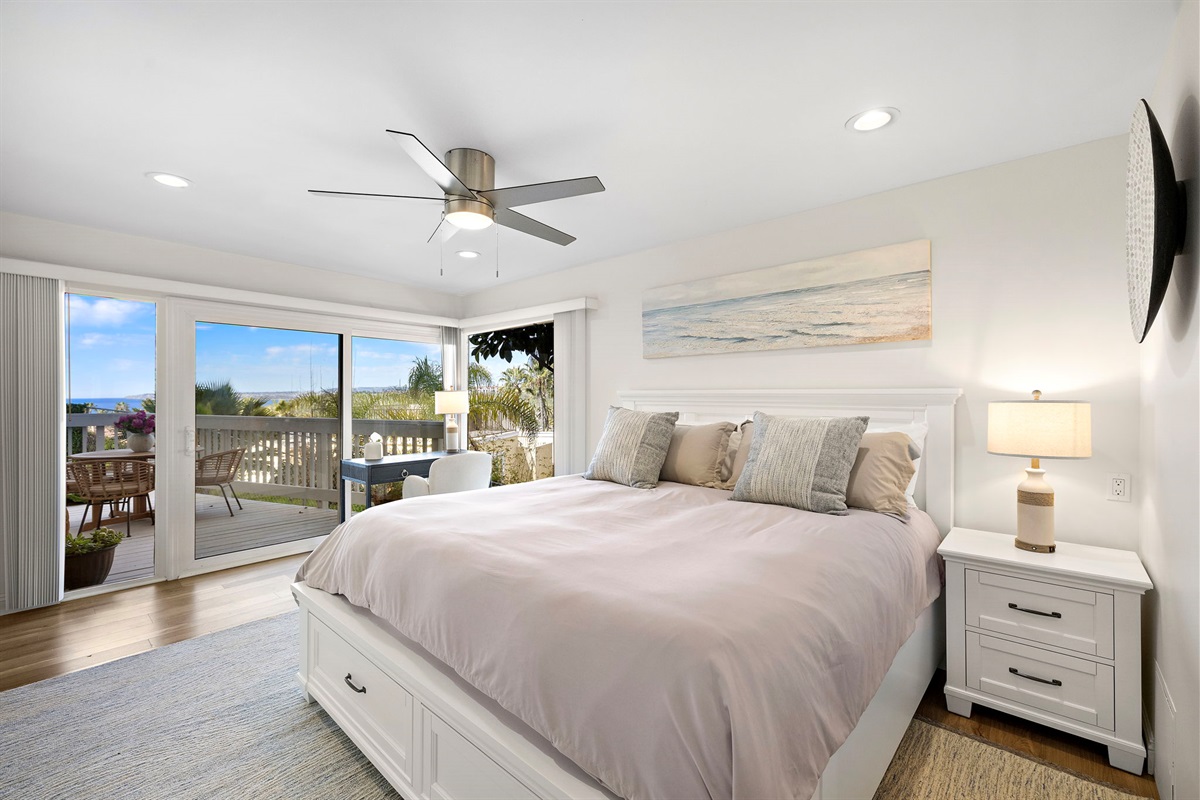 Drift off in the peaceful primary bedroom, featuring luxury bedding and calming coastal tones for a great night’s sleep.