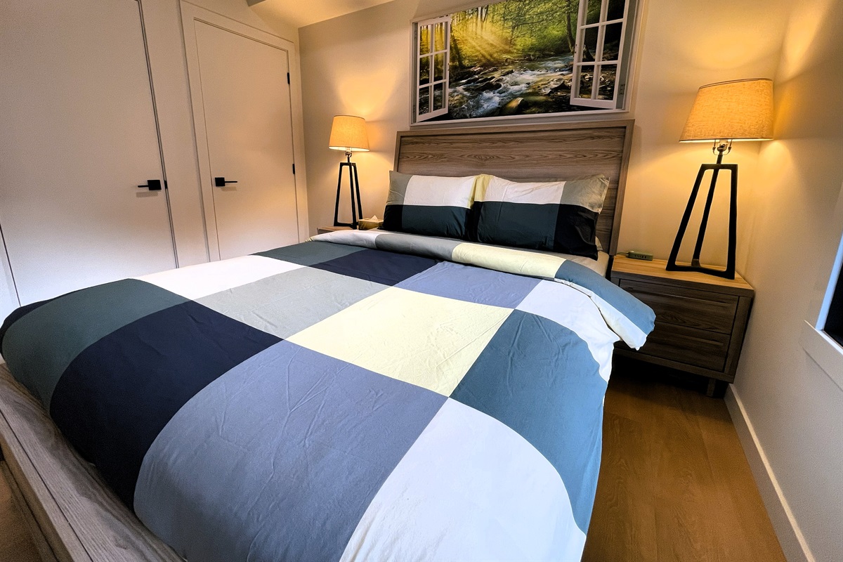 Queen bed, comfy with extra pillows. 55" TV compliments the interior decor. 