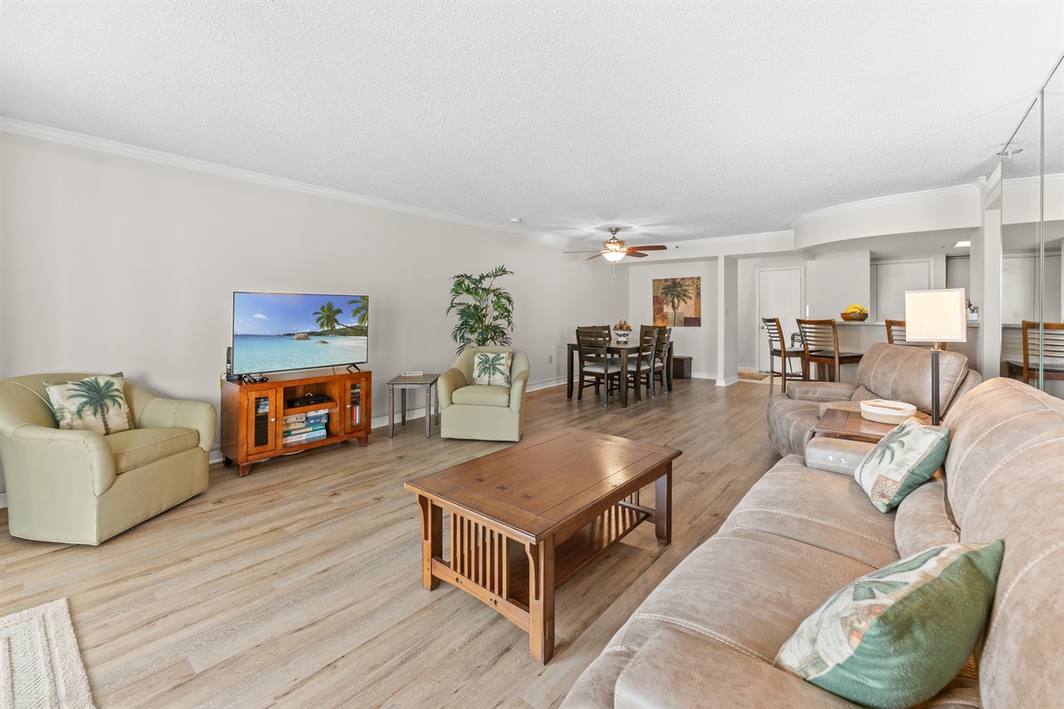 Spacious Living room with seating for everyone, large TV and balcony access