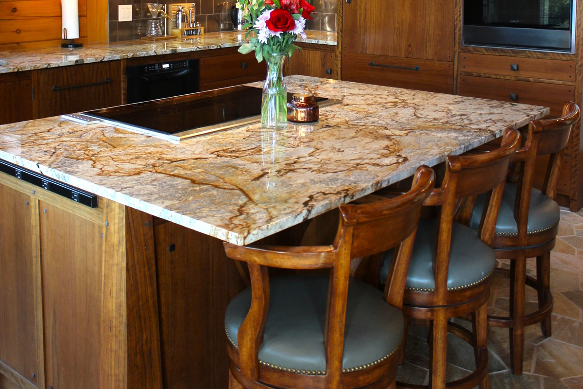 Large kitchen island with stove and 3 bar stools