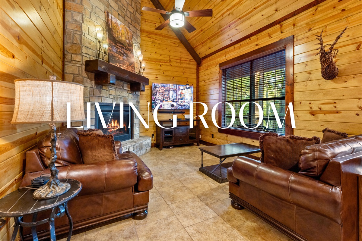 Inviting living area with leather seating and a stone fireplace — cozy perfection.