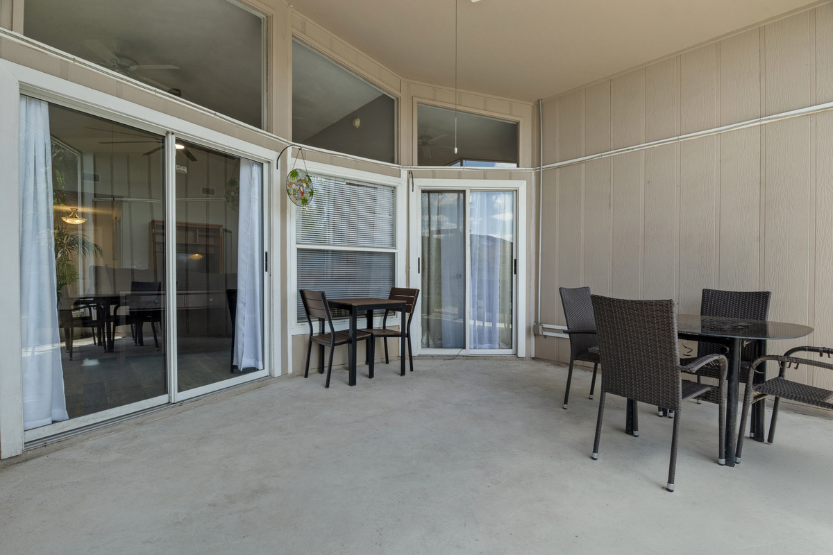 Expansive screened-in lanai offering seamless indoor-outdoor living with direct access from three areas of the home: the family room, kitchen, and primary bedroom.