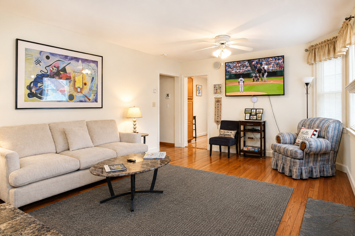 Living Room.  There are hardwood floors throughout the unit, with a granite tile floor in the fully tiled bathroom