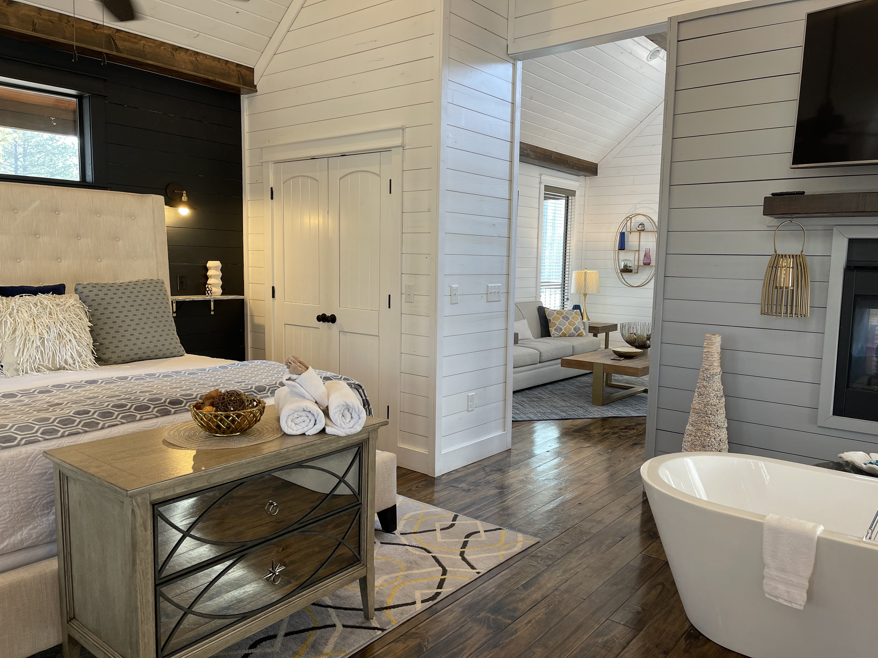 Master bedroom, king size bed and full soaking tub in front of the see through fireplace.