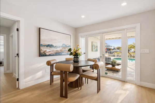 Dining area overlooking the pool with seating for family meals