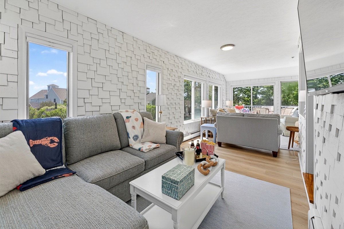 Airy and comfortable living area featuring wide windows that let in abundant natural light, creating a calm and inviting atmosphere.
