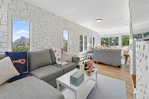 Airy and comfortable living area featuring wide windows that let in abundant natural light, creating a calm and inviting atmosphere.