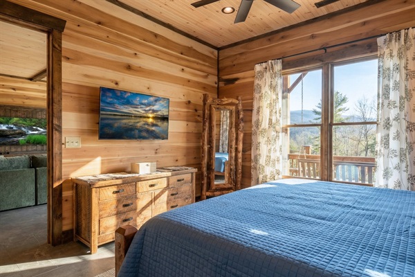 The comfortable downstairs master suite with a king bed, ready to provide a restful night's sleep.