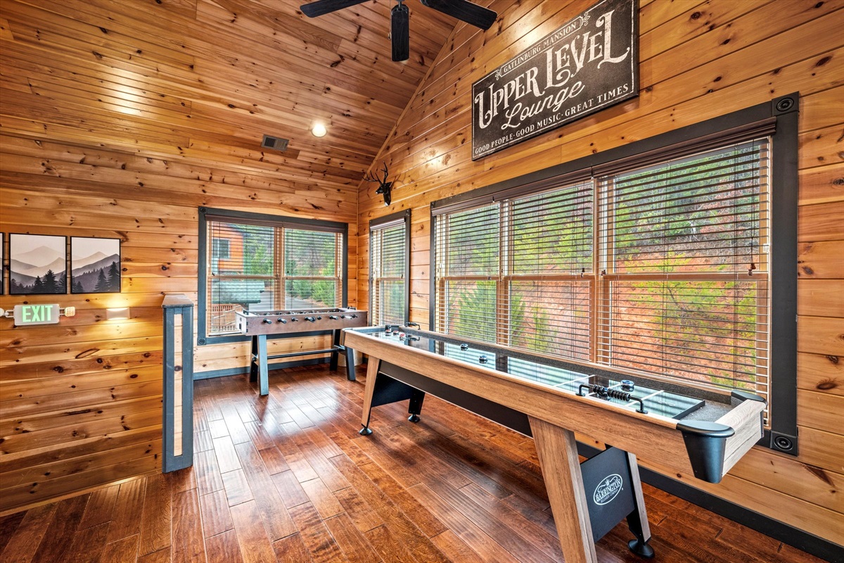 The shuffleboard table is in the upper bar/lounge