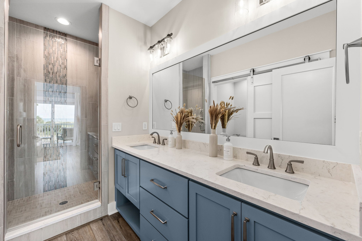 Another beautifully appointed full bathroom offers a double vanity and plenty of space.