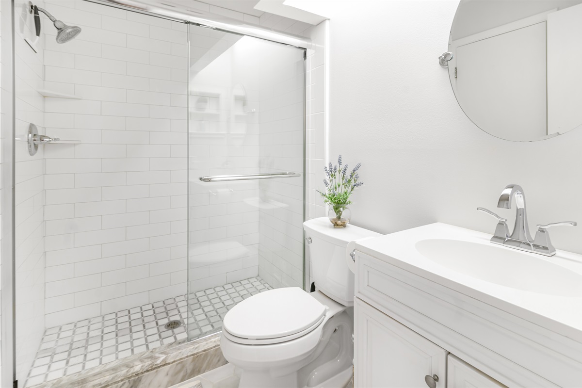 Attached to the main bedroom, this en-suite bathroom offers a clean, spacious layout with fresh towels and thoughtful touches.