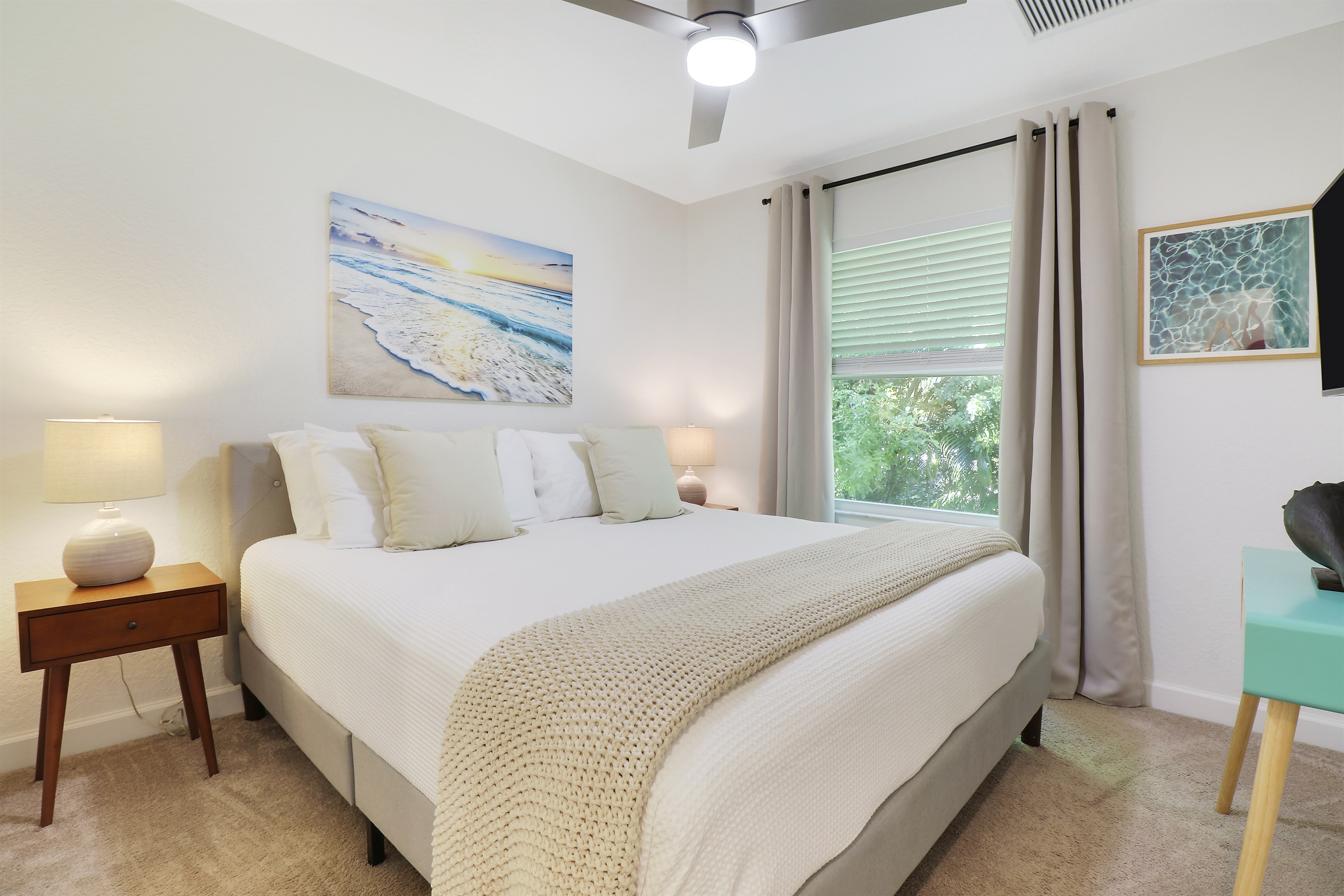 King guest bedroom, second floor. Walk in closet, hangers, small dresser, 55" TV, and, ceiling fan