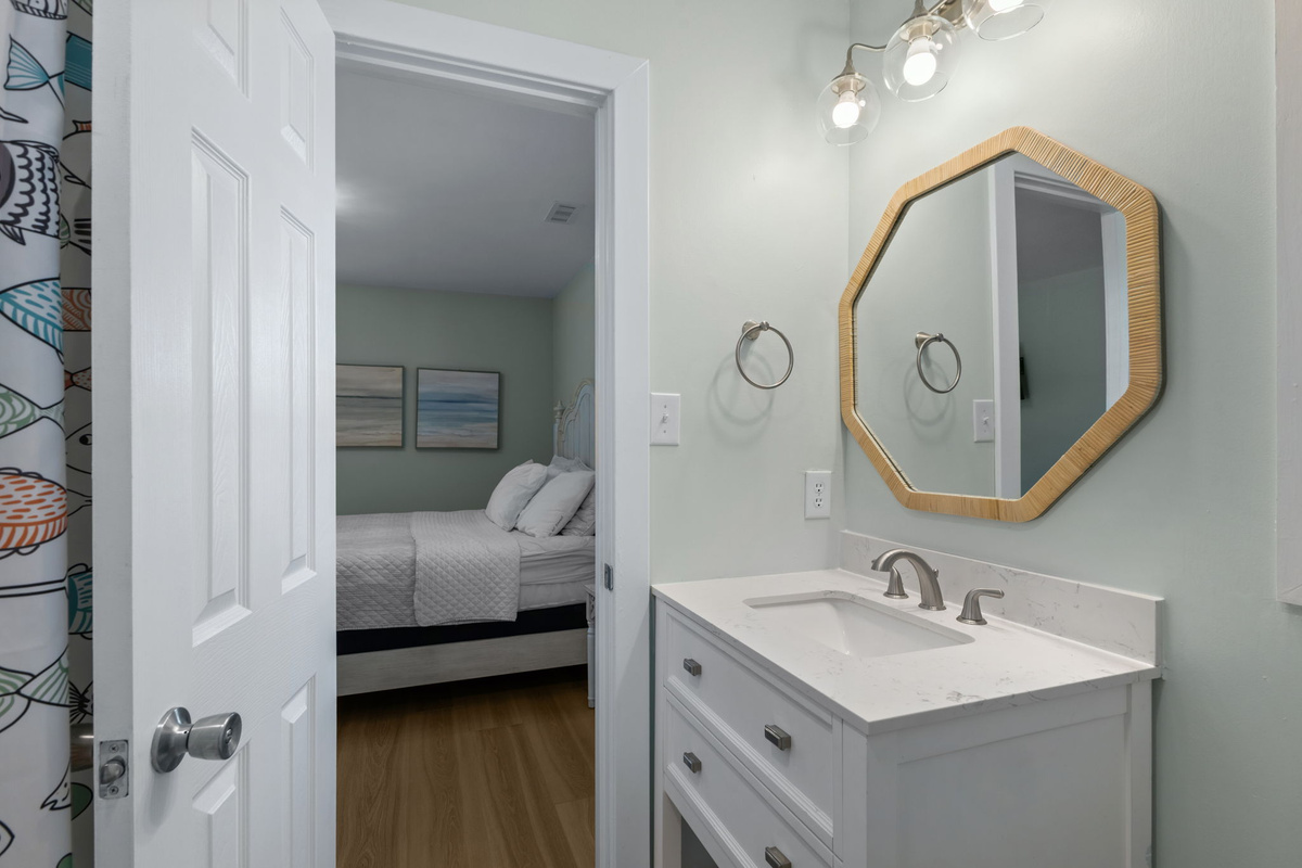 The ground floor bathroom features a modern vanity and a clean, refreshed design, making it easy to get ready for a day at the beach