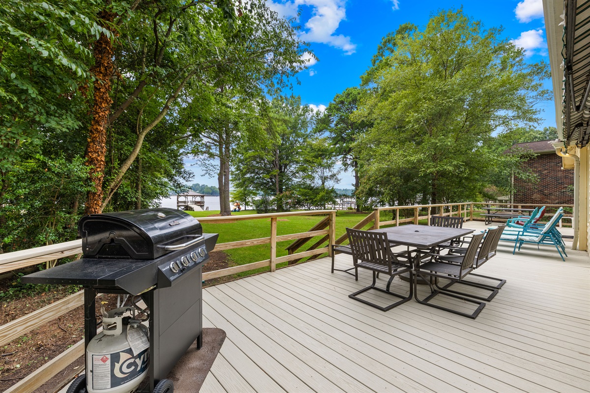 Large back deck with a grill, lounging, dining, and more!