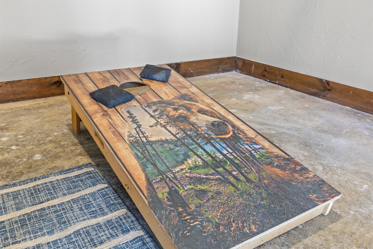 The game room table adds rustic charm, doubling as a great spot for card games or relaxed conversations.