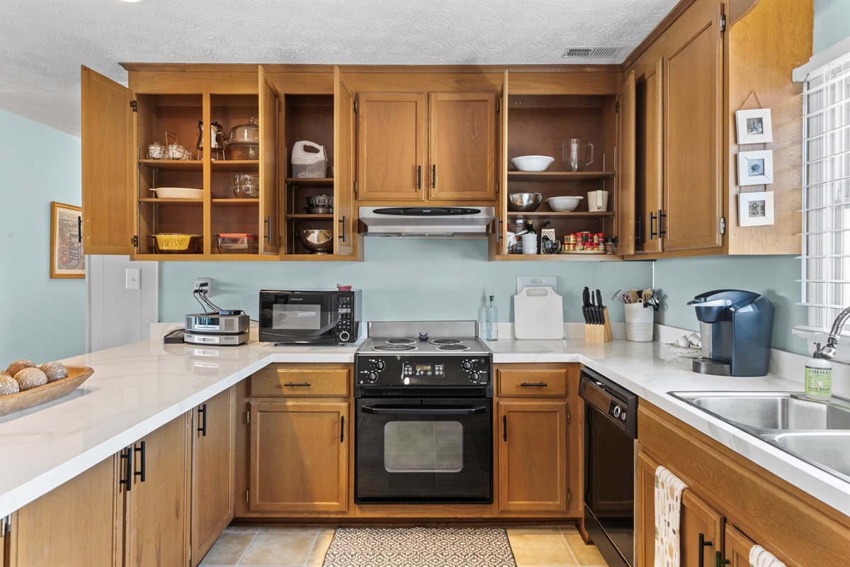 Kitchen Delight: Bright, spacious kitchen with modern appliances and charming decor awaits your culinary adventures!