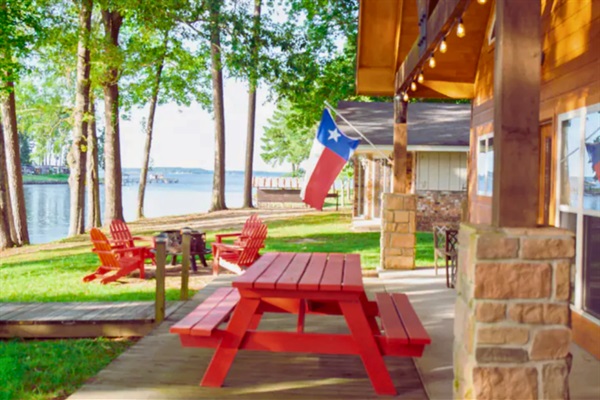 Covered outdoor seating overlooking the lake — shade + water views all day.