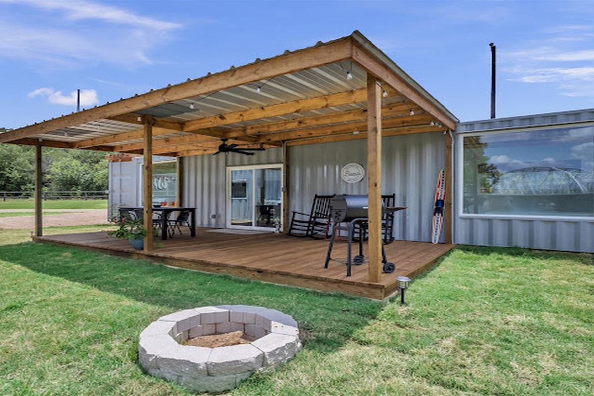Unwind outdoors with a cozy fire pit and comfortable porch seating.