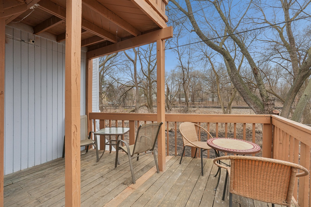 The spacious rear deck overlooks the woods, tracks and backyard.