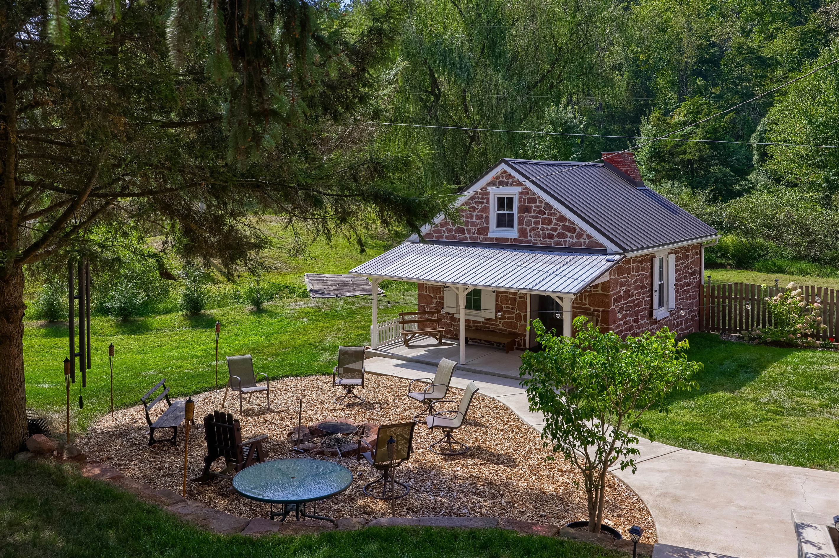 Summer Kitchen, outfitted with a King bed, mini kitchen, hearth. We stock water bottles for you!