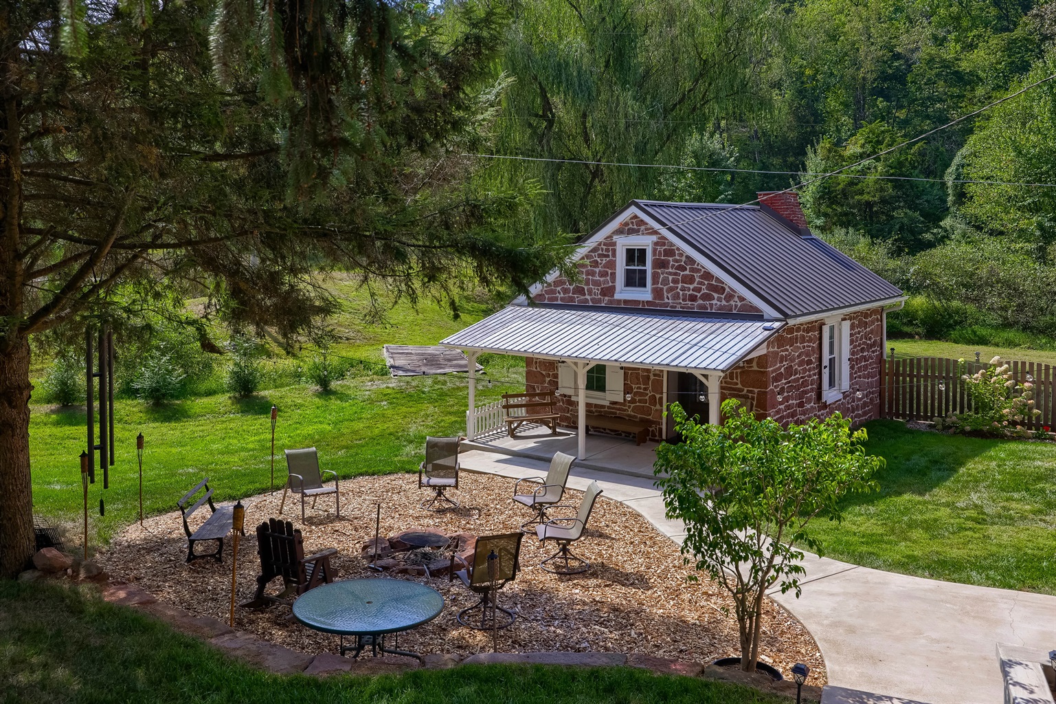 Summer Kitchen, outfitted with a King bed, mini kitchen, hearth. We stock water bottles for you!