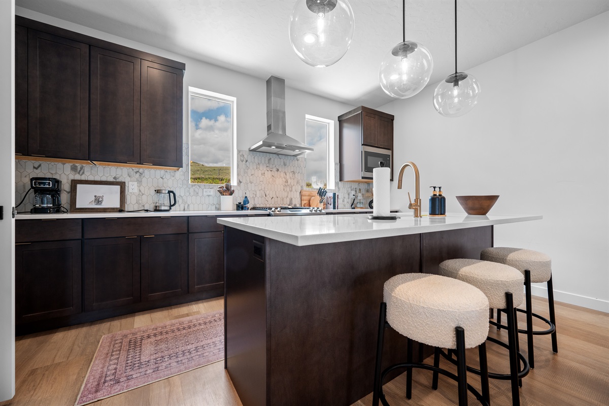 Large kitchen island with seating for three—ideal for meals, drinks, and conversation.